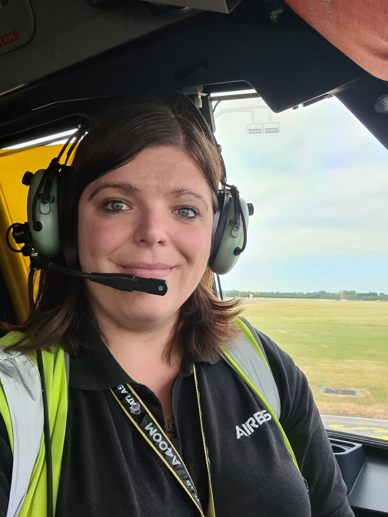 Steph, aircraft engineer with a headset on in an aircraft