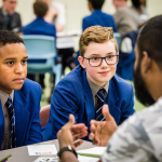 Boys talking to volunteer