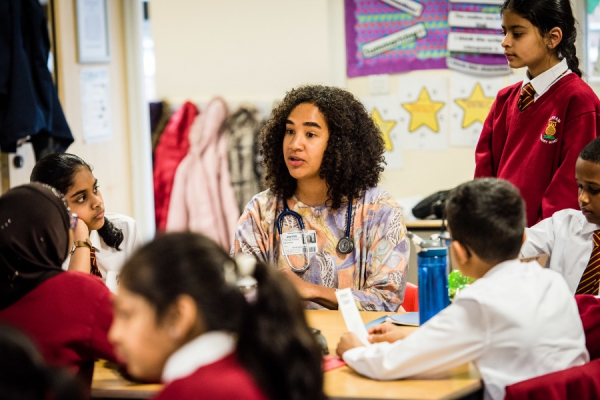 Doctor talking with primary school pupils