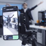 Digital creative image with phone digitally enhancing a man jumping in the background