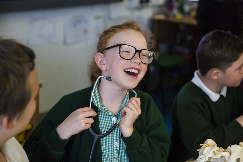 primary girl stethoscope laughng