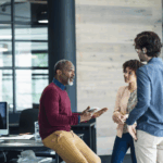 HR manager sitting and talking to two younger colleagues