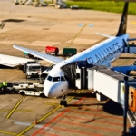 Star Alliance plane on the ground with people working around it to get it ready for takeoff