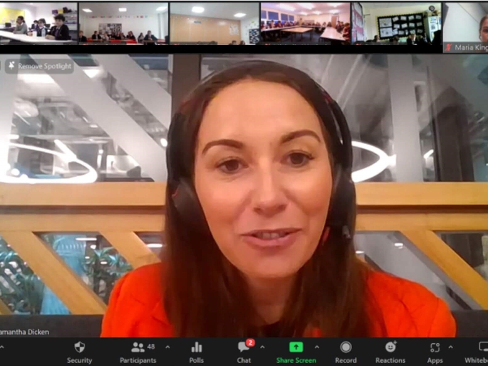 female volunteer from a company speaks to students over Zoom about her job and experiences.